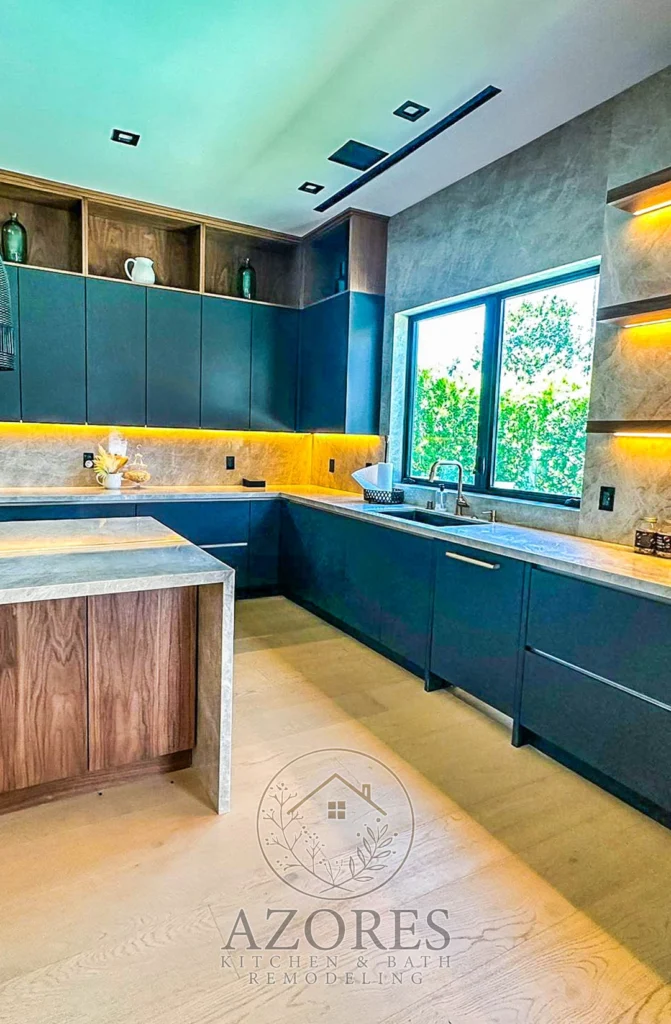 Modern kitchen with sleek black cabinets, a marble countertop, and stainless steel appliances.