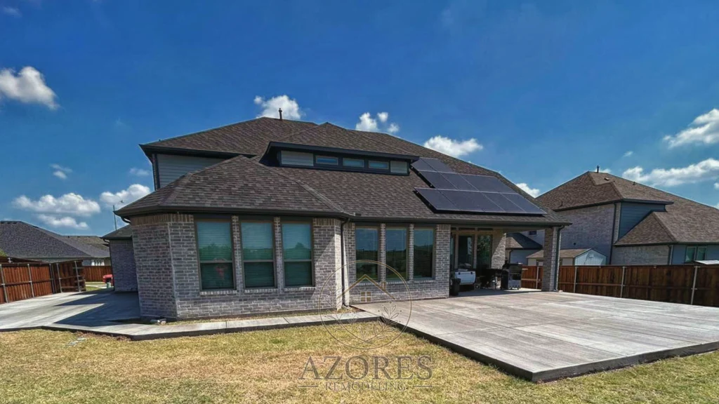 Freshly poured concrete driveway and pathway with a smooth finish, surrounded by a landscaped yard.