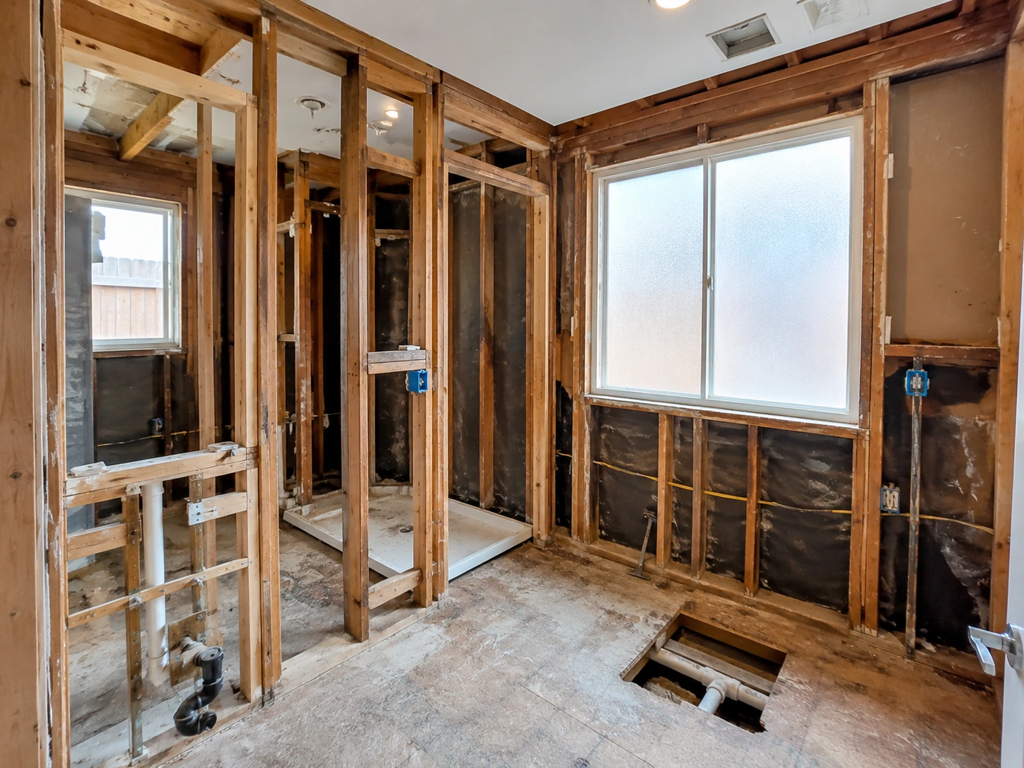 Bathroom demolition and rough-in phase during a DFW remodel